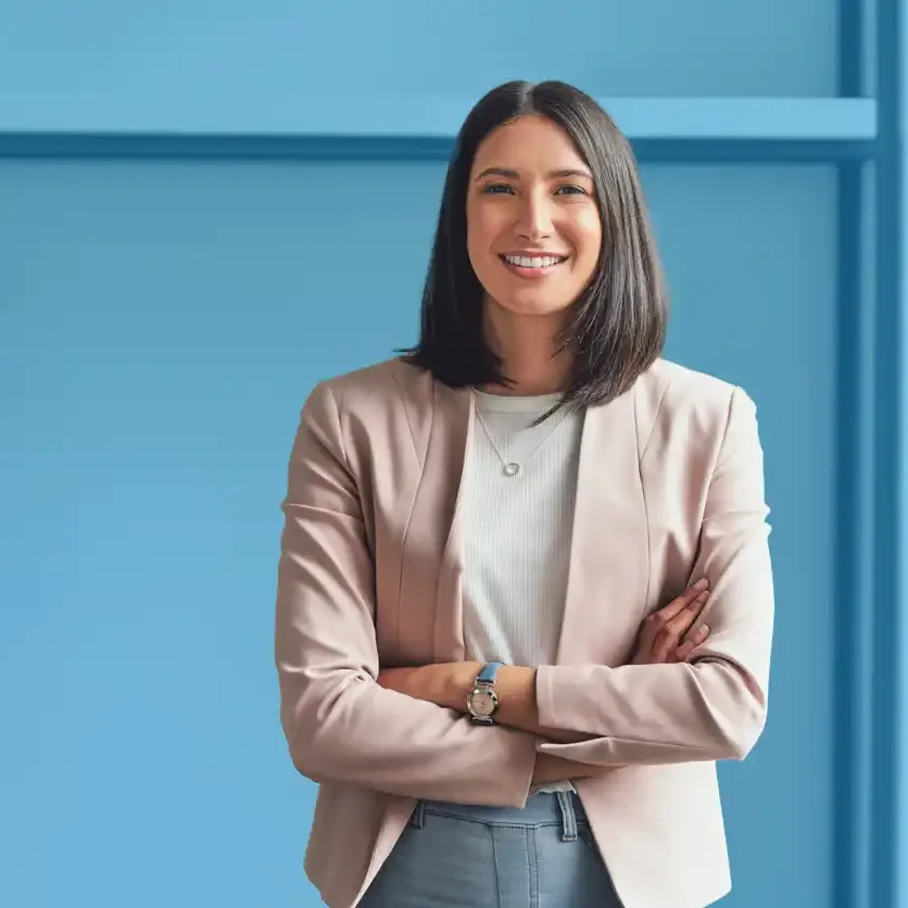 content marketing australia.jpg Smiling female content marketer in front of blue background.
