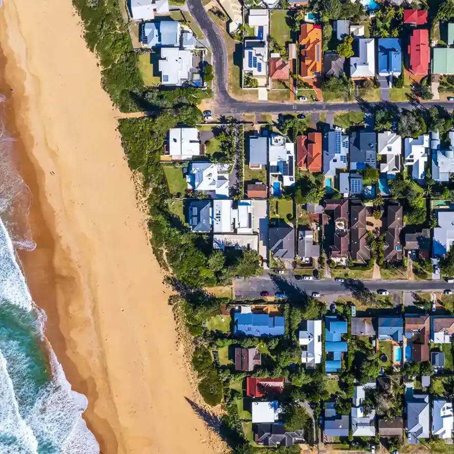 Drone shot of suburb in australia against the coastline