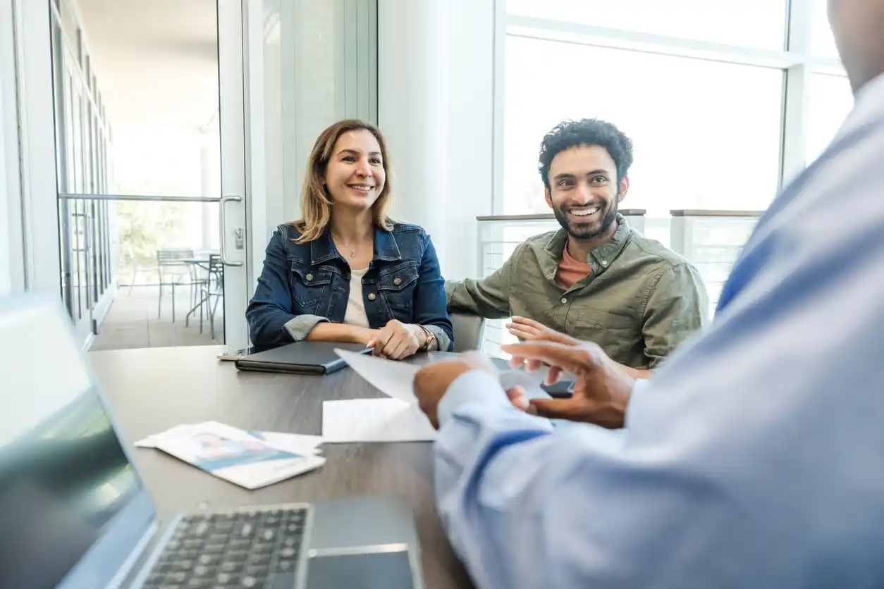 accountant discussing with clients at office desk