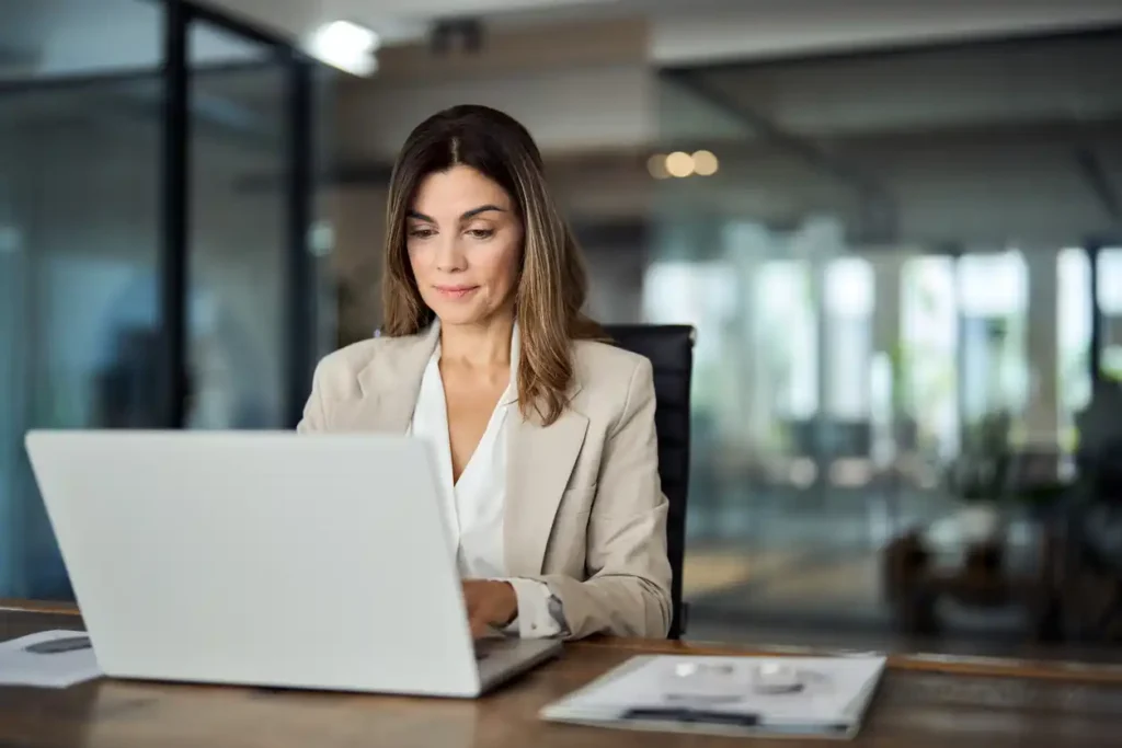 Female finance expert in front of laptop in modern office.